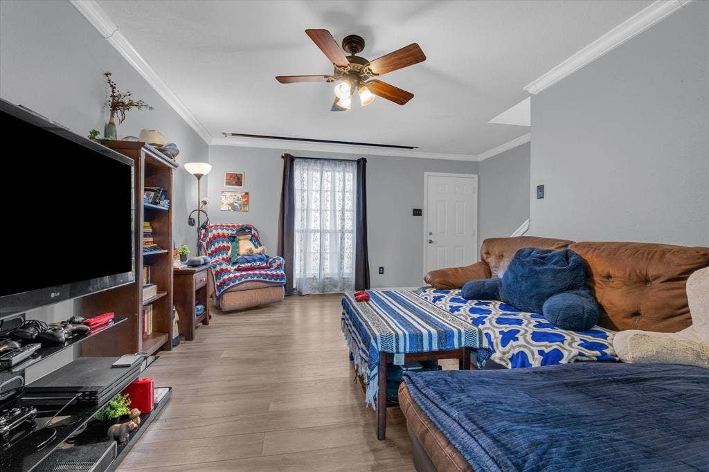 1349 S 11th Street, Waco, TX 76706 Bedroom with crown molding, ceiling fan, and light wood-style floors