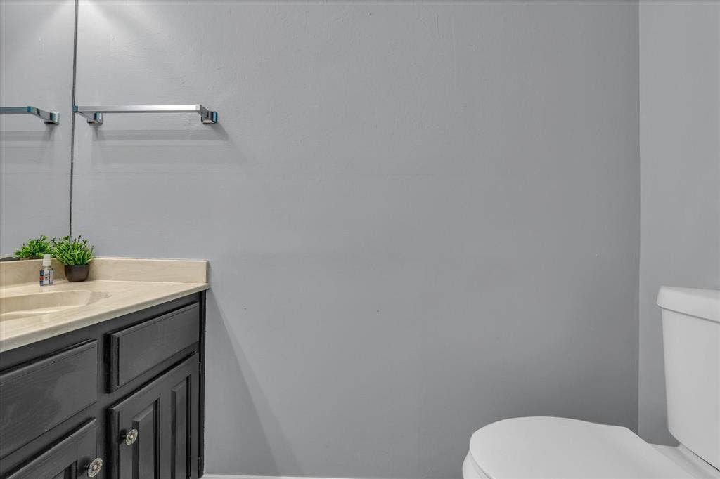1349 S 11th Street, Waco, TX 76706 Half bathroom featuring toilet and vanity