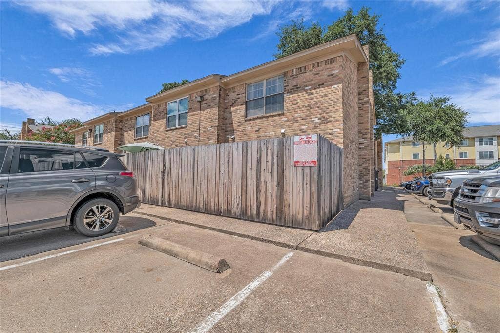 1349 S 11th Street, Waco, TX 76706 View of property exterior featuring uncovered parking and brick siding