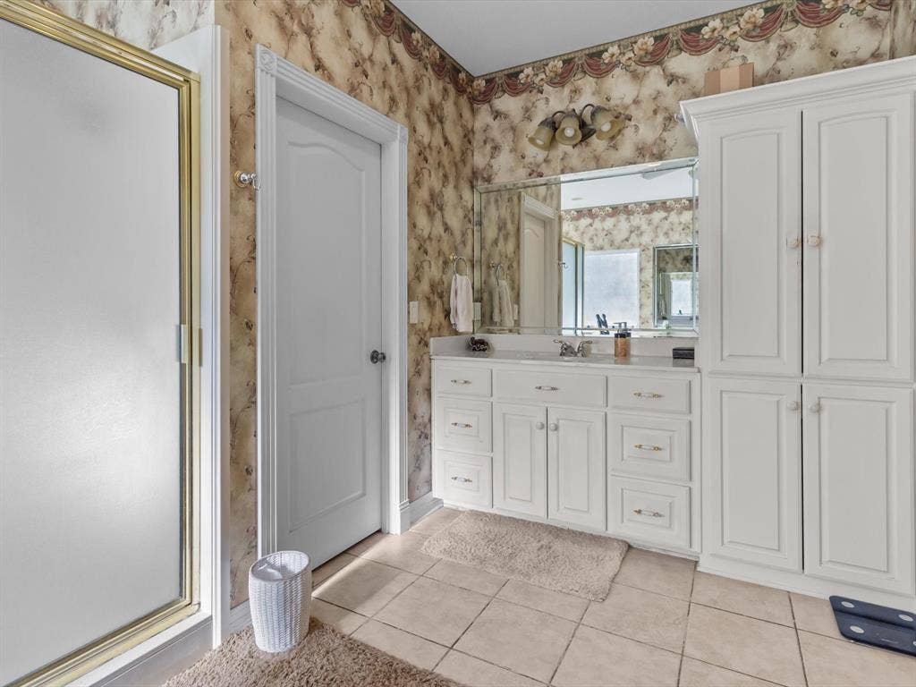 20941 Fm 16 W, Lindale, TX 75771 Full bathroom featuring light tile patterned flooring, a stall shower, vanity, and wallpapered walls