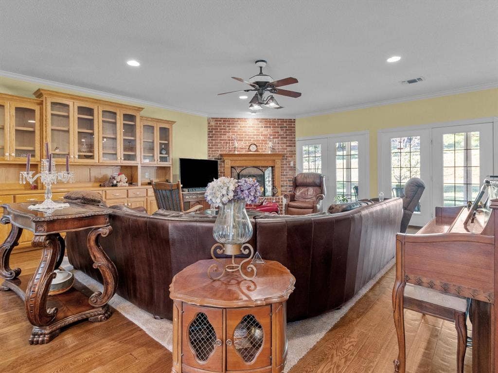 20941 Fm 16 W, Lindale, TX 75771 Living area with ornamental molding, a brick fireplace, light wood finished floors, recessed lighting, and ceiling fan