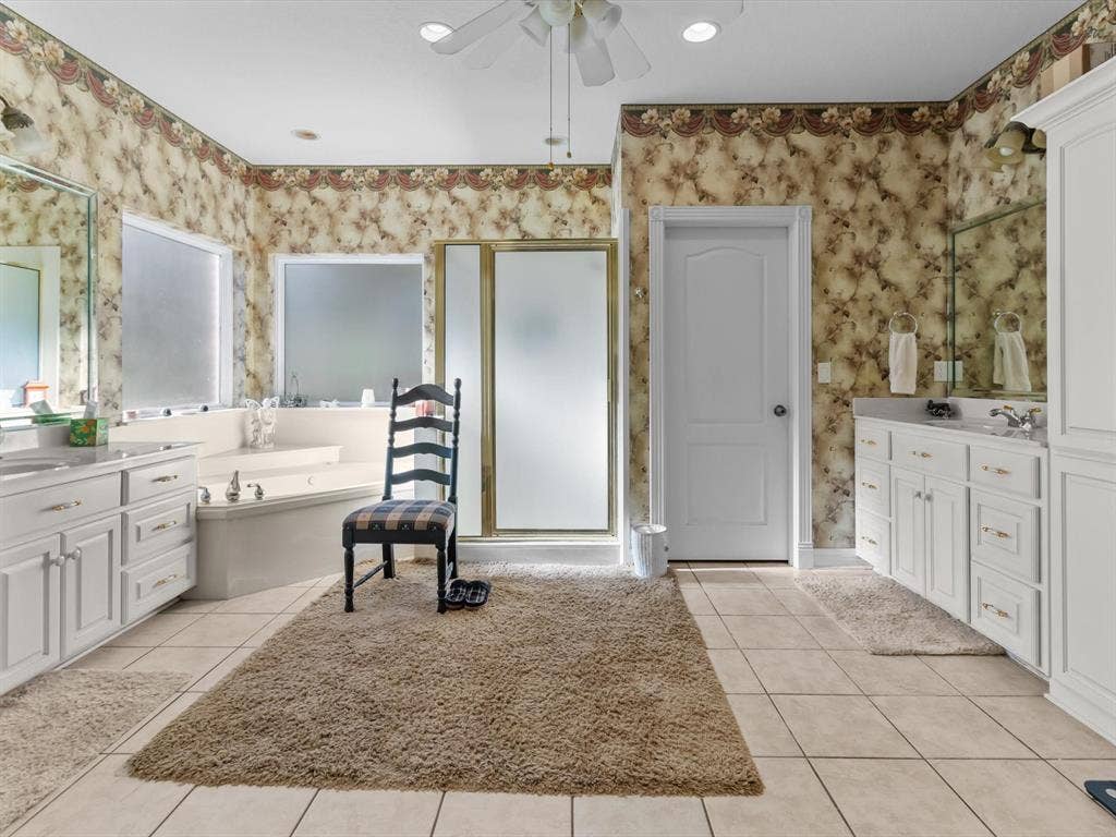 20941 Fm 16 W, Lindale, TX 75771 Full bathroom featuring light tile patterned flooring, vanity, a freestanding bath, a shower stall, and wallpapered walls