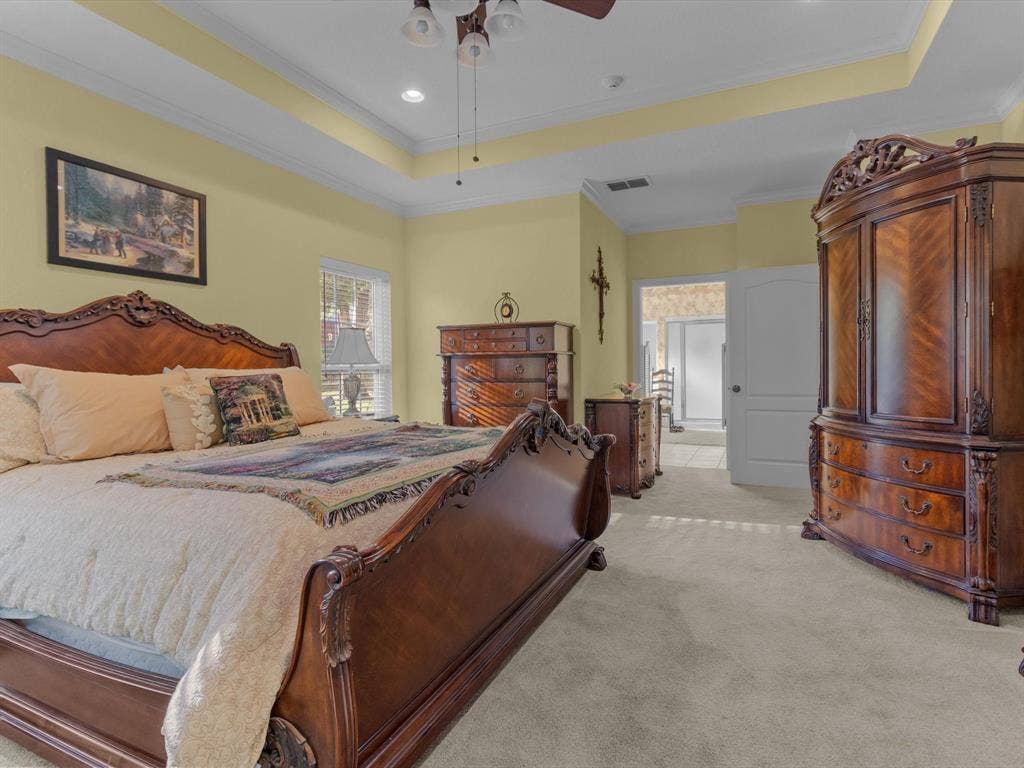 20941 Fm 16 W, Lindale, TX 75771 Bedroom featuring a tray ceiling, light colored carpet, crown molding, a ceiling fan, and recessed lighting