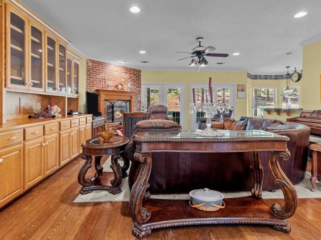 20941 Fm 16 W, Lindale, TX 75771 Living room with ornamental molding, a brick fireplace, light wood-style floors, plenty of natural light, and recessed lighting