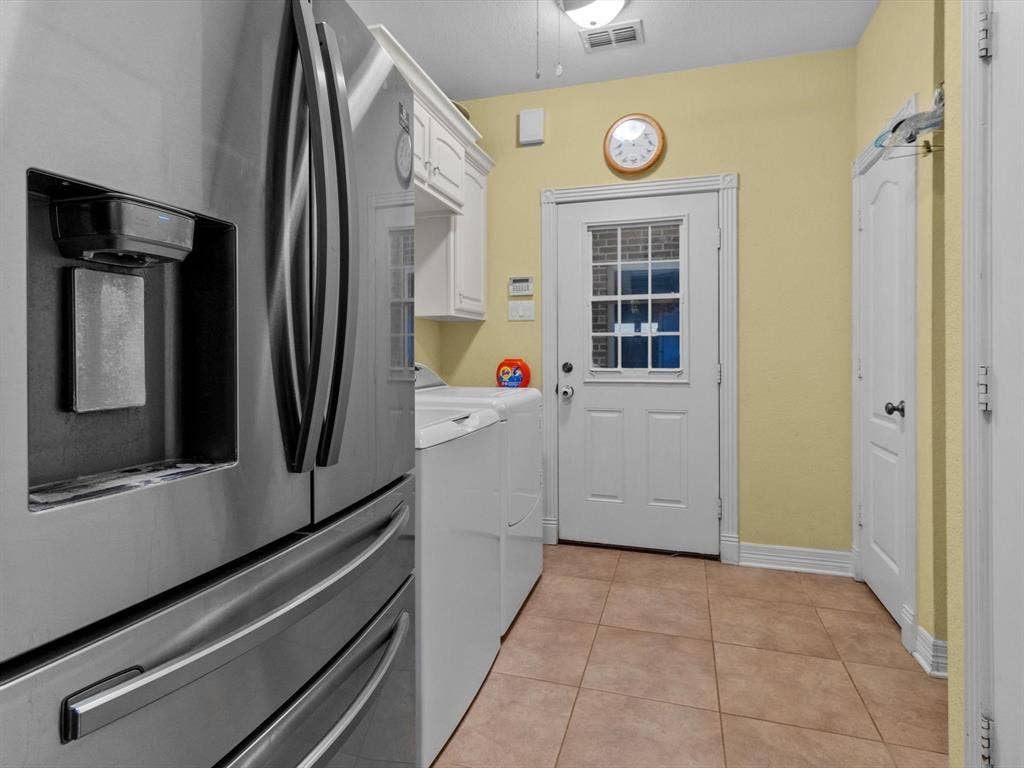 20941 Fm 16 W, Lindale, TX 75771 Laundry area with light tile patterned floors, independent washer and dryer, and cabinet space