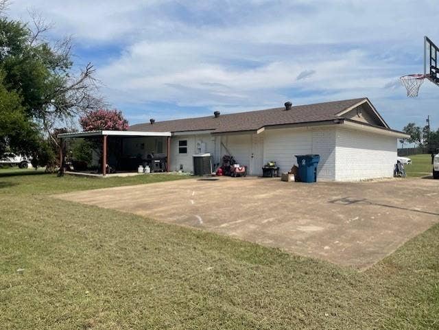 Rear view of property featuring a yard