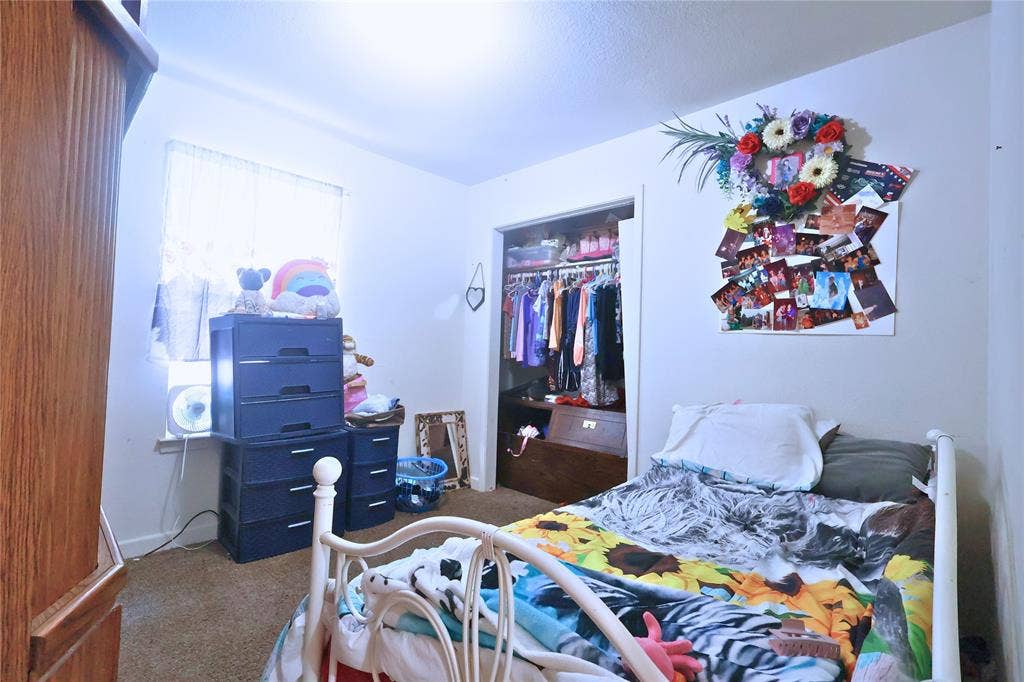 14186 Austin Street, Log Cabin, TX 75148 Carpeted bedroom featuring a closet