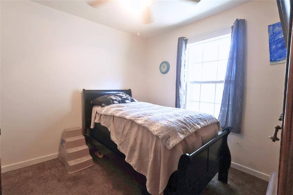 14186 Austin Street, Log Cabin, TX 75148 Bedroom with ceiling fan and dark carpet