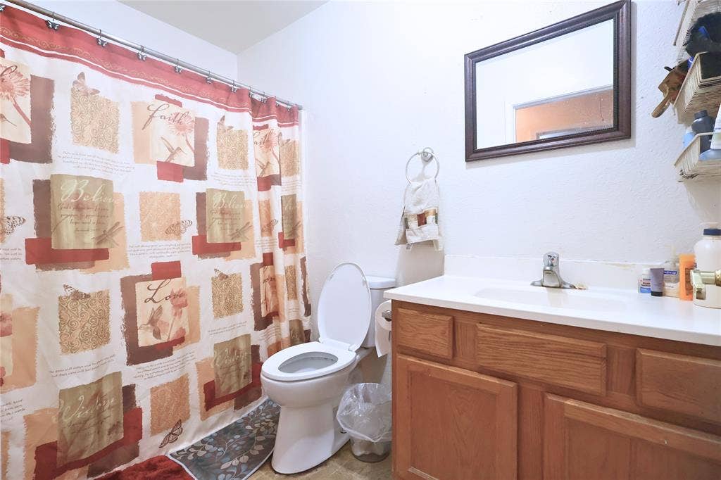 14186 Austin Street, Log Cabin, TX 75148 Bathroom featuring vanity and curtained shower