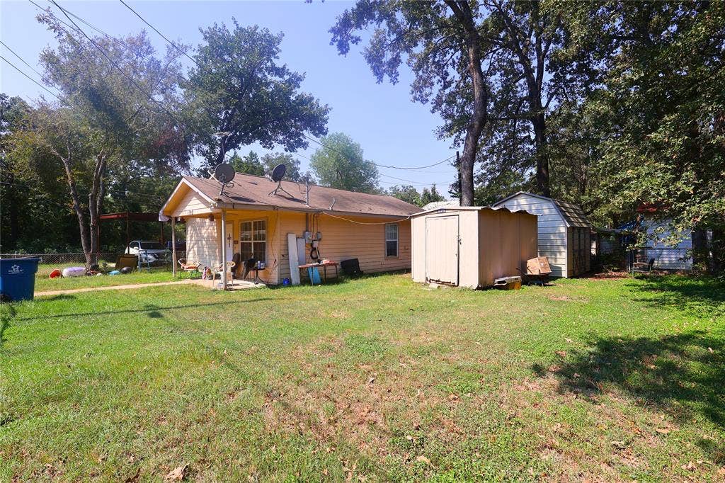 14186 Austin Street, Log Cabin, TX 75148 Back of property with a shed and a patio
