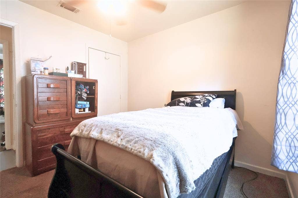 14186 Austin Street, Log Cabin, TX 75148 Bedroom with a closet, carpet floors, and a ceiling fan