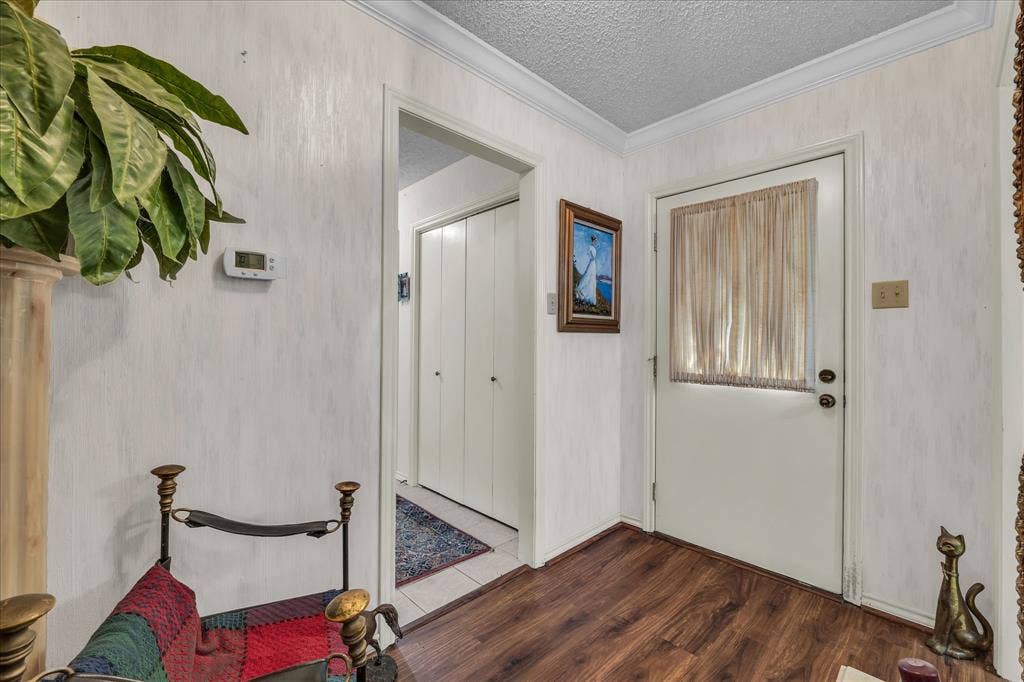 3405 Edna Avenue, Waco, TX 76708 Entryway featuring ornamental molding, dark wood-type flooring, and a textured ceiling