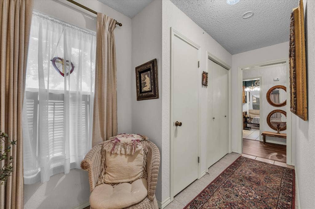 3405 Edna Avenue, Waco, TX 76708 Hallway featuring a textured ceiling and tile patterned floors
