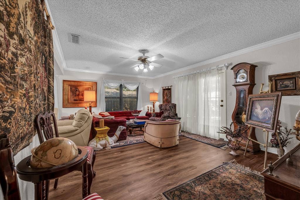 3405 Edna Avenue, Waco, TX 76708 Living area with wood finished floors, crown molding, a textured ceiling, and ceiling fan
