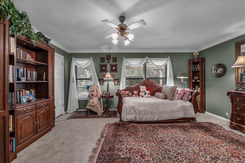 3405 Edna Avenue, Waco, TX 76708 Bedroom with multiple windows, light carpet, ornamental molding, and a ceiling fan