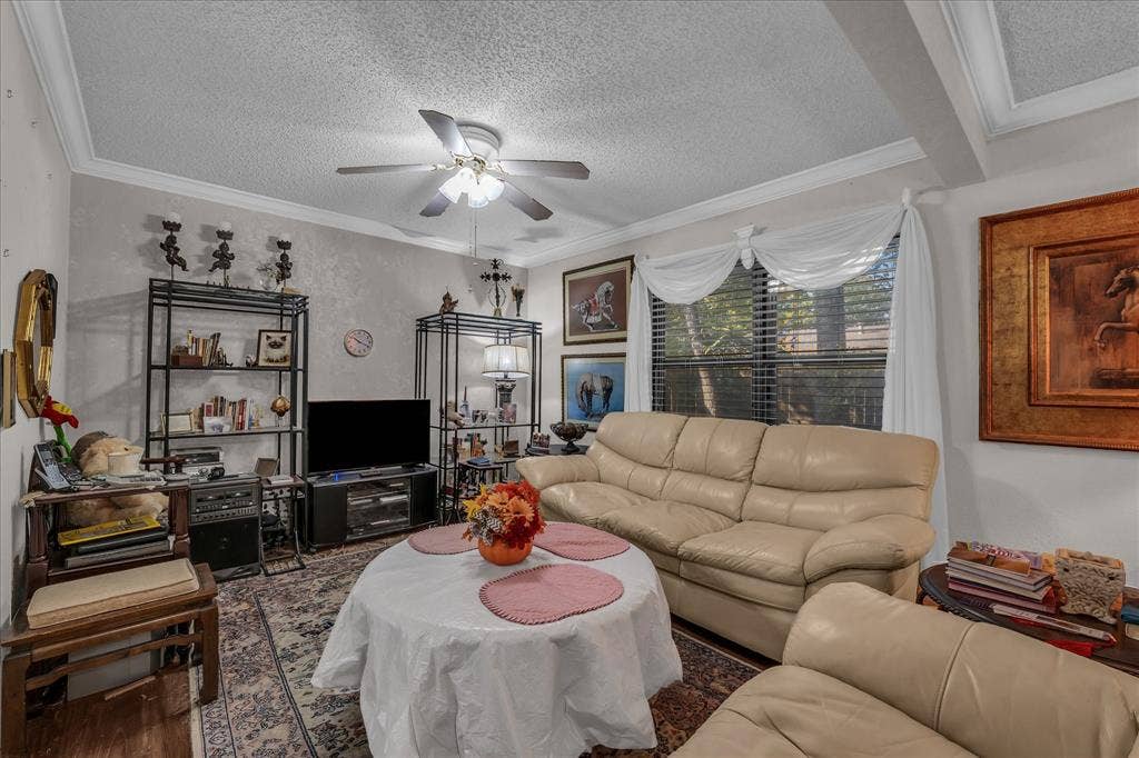 3405 Edna Avenue, Waco, TX 76708 Living area featuring a textured ceiling, ornamental molding, ceiling fan, and wood finished floors