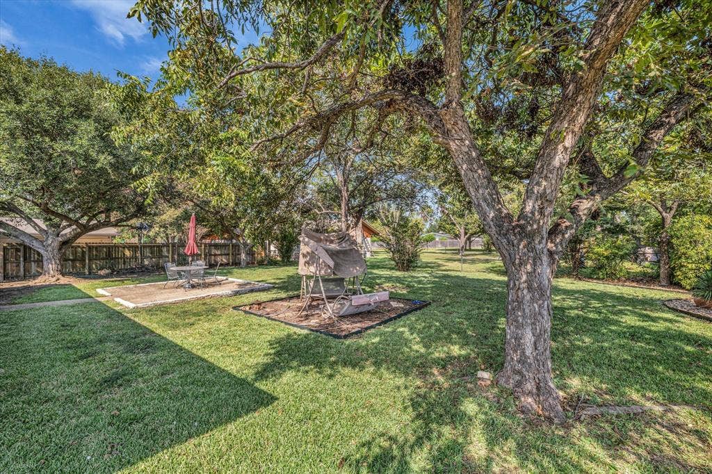 3405 Edna Avenue, Waco, TX 76708 View of yard with a patio and view of wooded area