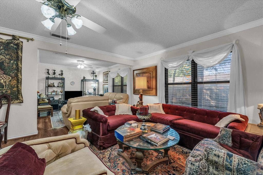 3405 Edna Avenue, Waco, TX 76708 Living room featuring a textured ceiling, wood finished floors, ornamental molding, and ceiling fan