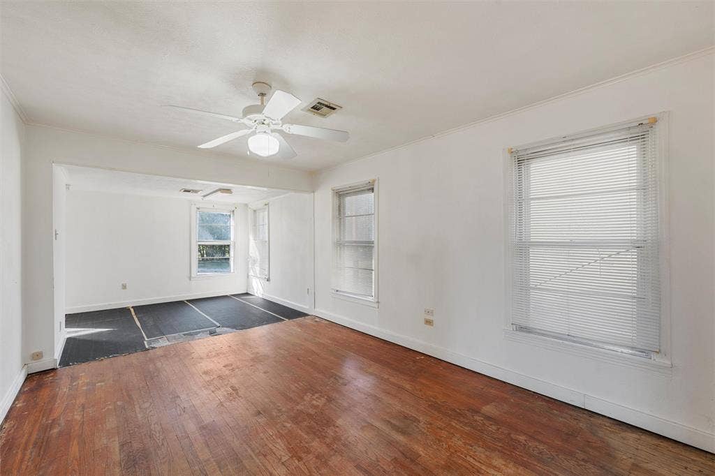 12145 Tree Lake Drive, Waco, TX 76708 Unfurnished room with dark wood-style floors, ornamental molding, and a ceiling fan