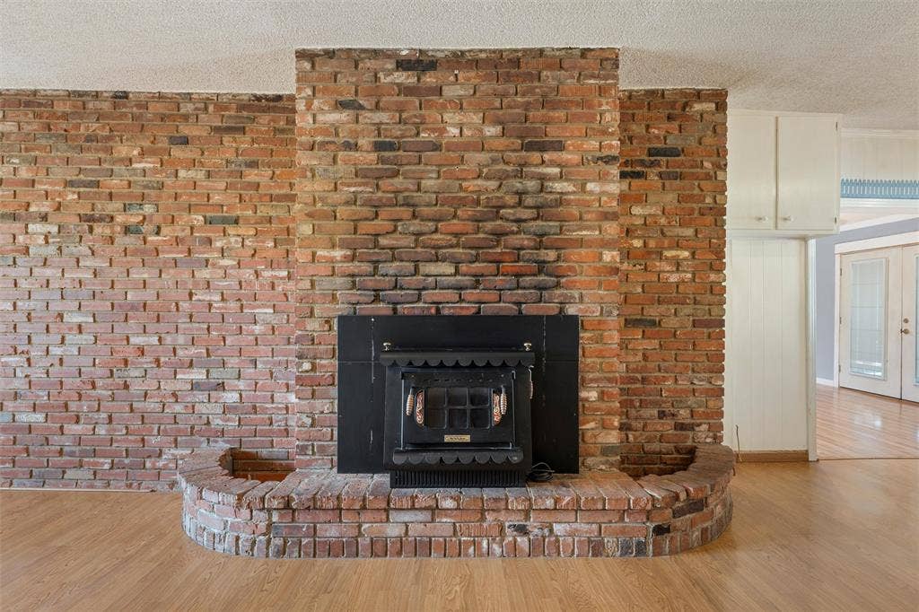 12145 Tree Lake Drive, Waco, TX 76708 Detailed view of wood finished floors and a textured ceiling