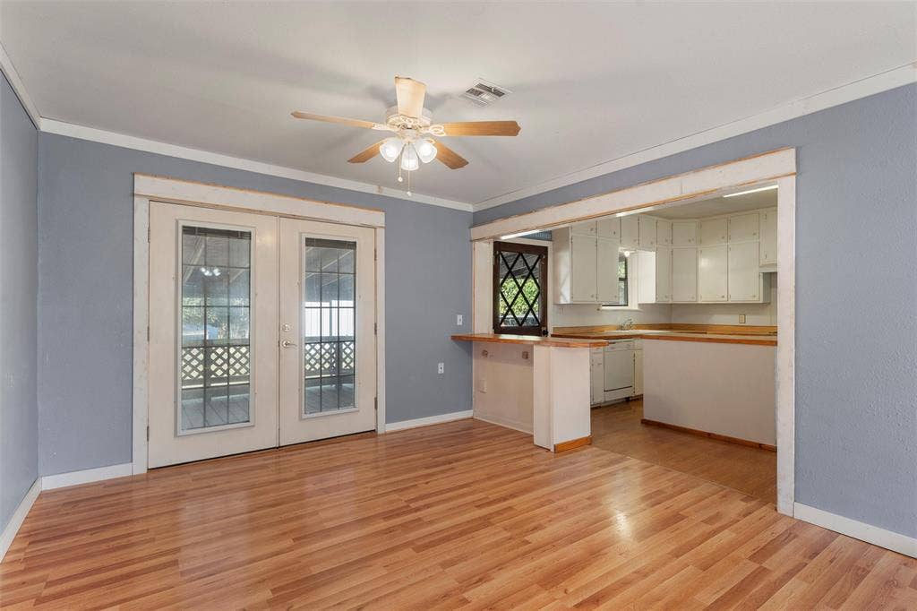 12145 Tree Lake Drive, Waco, TX 76708 Kitchen featuring french doors, a peninsula, light wood-style flooring, ceiling fan, and white dishwasher