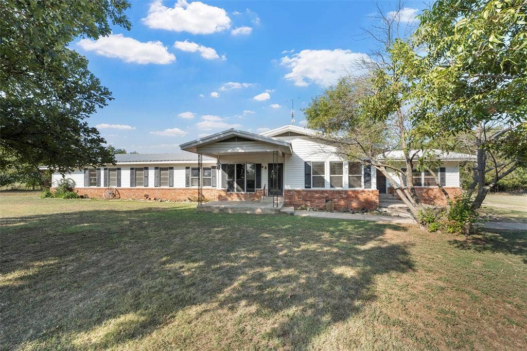 12145 Tree Lake Drive, Waco, TX 76708 View of front of home featuring brick siding and a front lawn