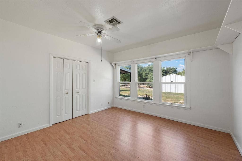 12145 Tree Lake Drive, Waco, TX 76708 Unfurnished bedroom featuring light wood finished floors, a closet, and a ceiling fan