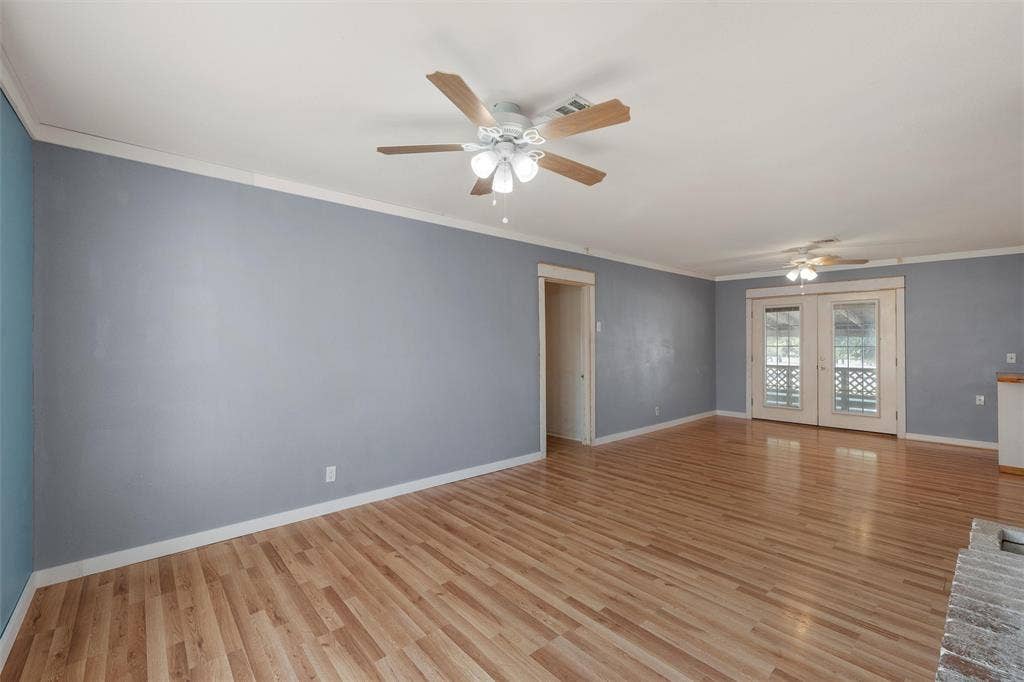 12145 Tree Lake Drive, Waco, TX 76708 Spare room with crown molding, light wood-type flooring, french doors, and ceiling fan