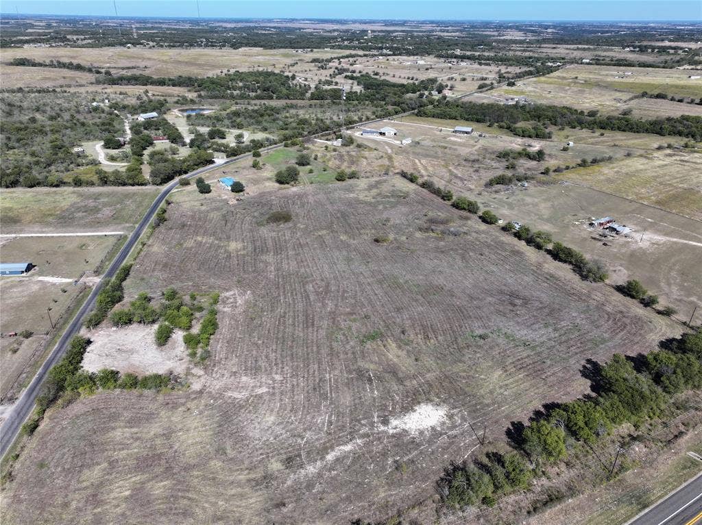 Aerial view of property's location with rural landscape and extensive farmland