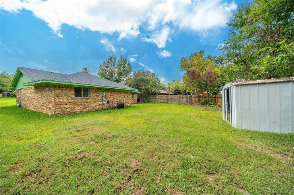 105 Briar Lane, Waxahachie, TX 75165 View of yard featuring a storage unit