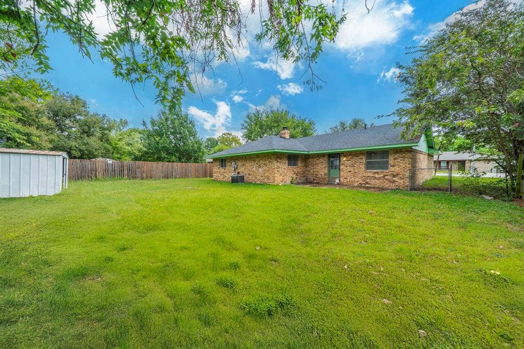 105 Briar Lane, Waxahachie, TX 75165 Fenced backyard with a storage unit
