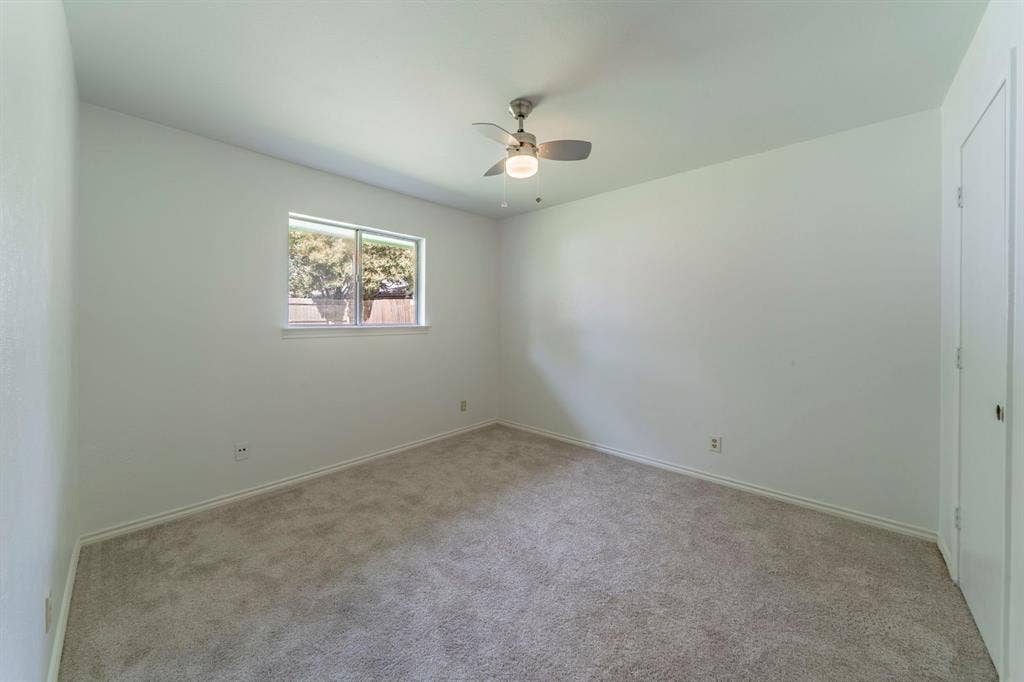 105 Briar Lane, Waxahachie, TX 75165 Carpeted empty room with ceiling fan and baseboards