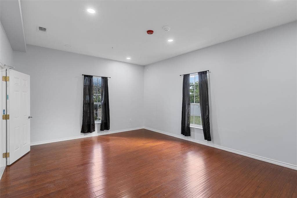 Empty room featuring recessed lighting, hardwood / wood-style floors, and healthy amount of natural light