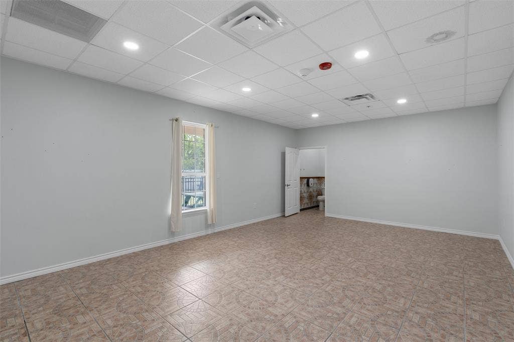 Empty room featuring a paneled ceiling and recessed lighting