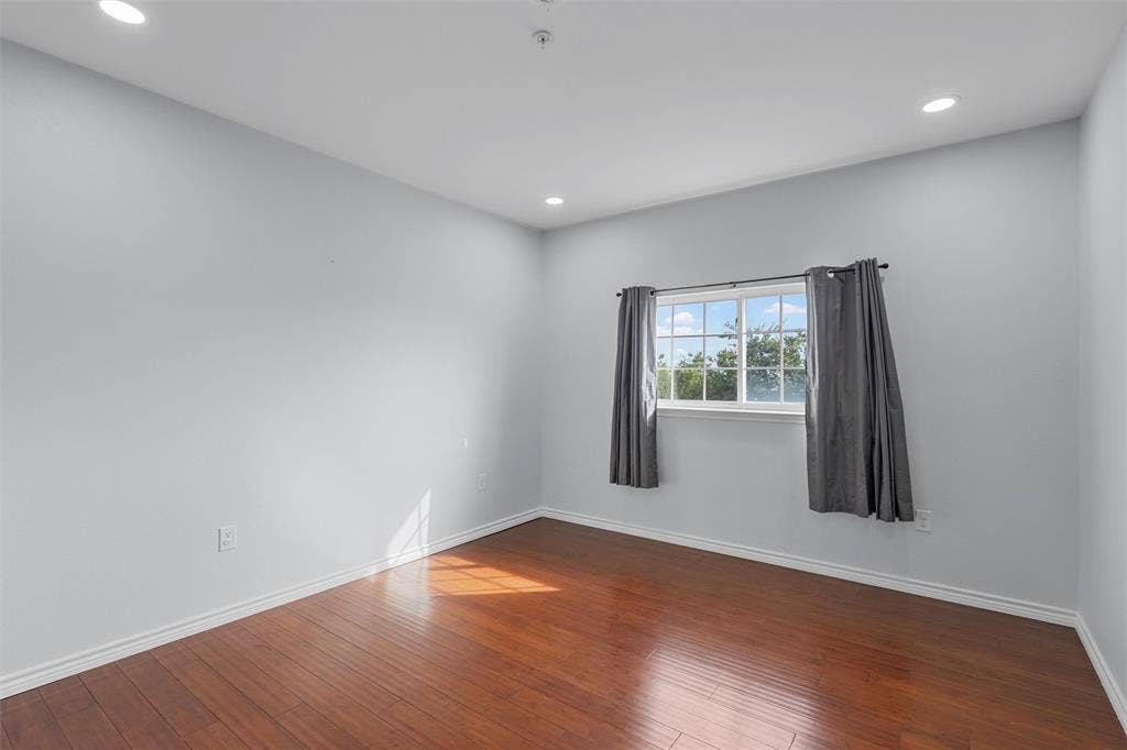 Spare room with recessed lighting and dark wood-style flooring