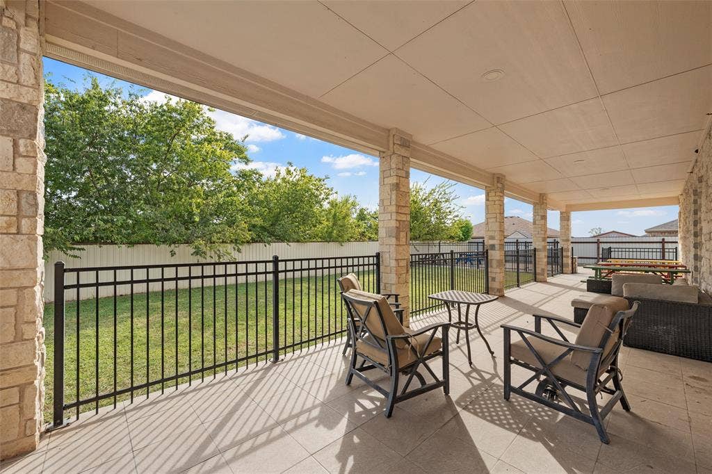 Fenced backyard with a patio area and an outdoor living space