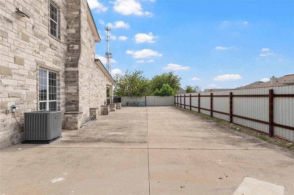 Fenced backyard with a patio