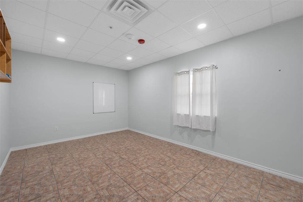 Empty room featuring a paneled ceiling and recessed lighting