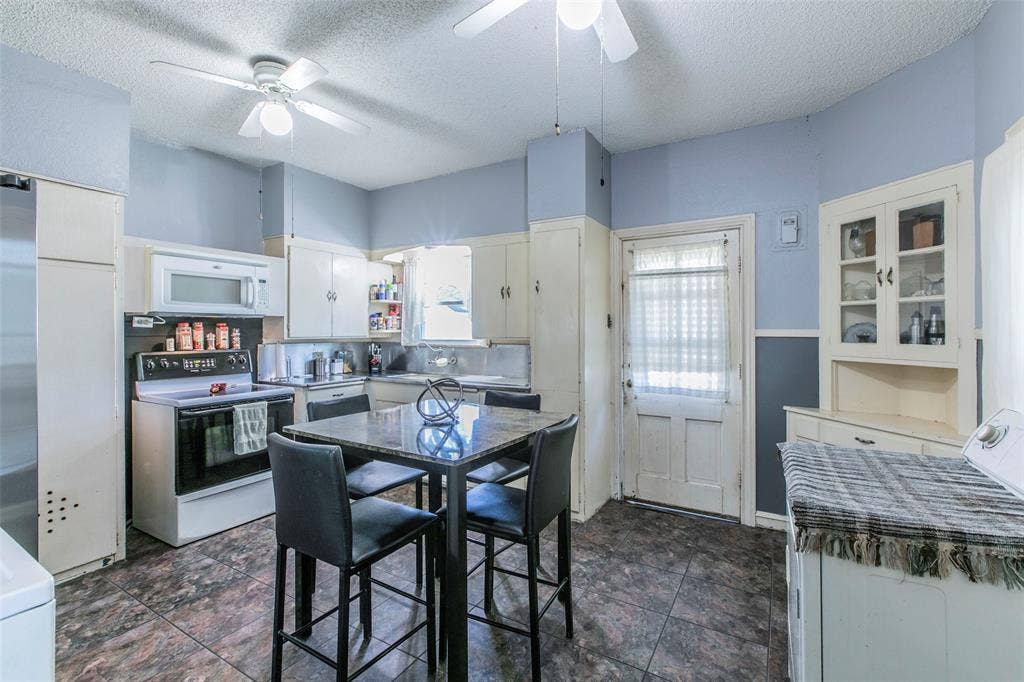 2603 Pine Avenue, Waco, TX 76708 Kitchen featuring white appliances, washer / clothes dryer, a textured ceiling, white cabinetry, and a ceiling fan