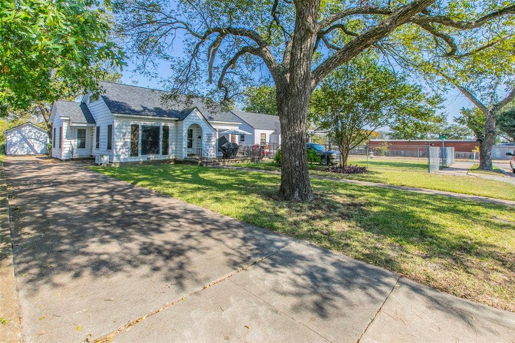 2603 Pine Avenue, Waco, TX 76708 View of front of property with an outdoor structure, roof with shingles, and a garage