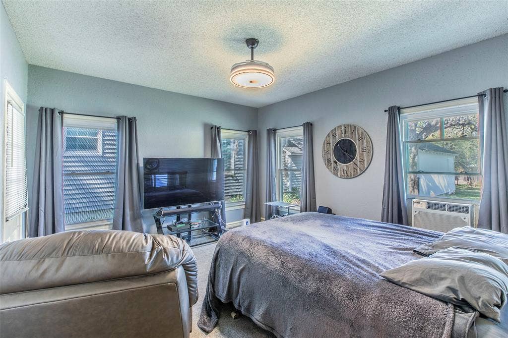 2603 Pine Avenue, Waco, TX 76708 Carpeted bedroom with a textured ceiling and cooling unit