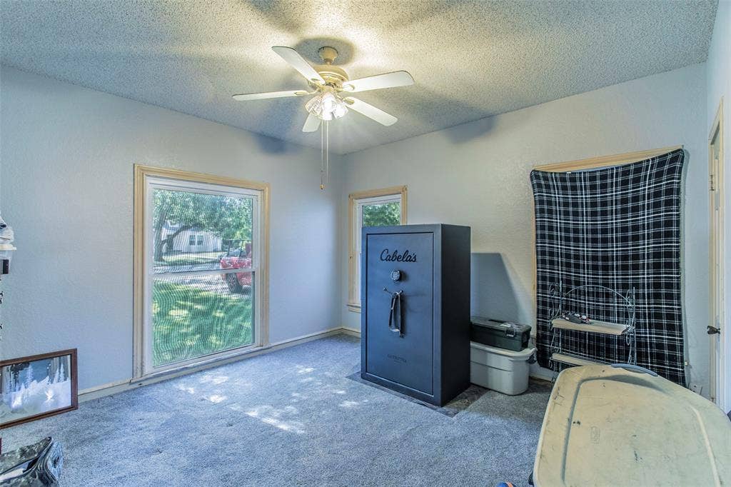 2603 Pine Avenue, Waco, TX 76708 Carpeted home office featuring a textured ceiling and ceiling fan