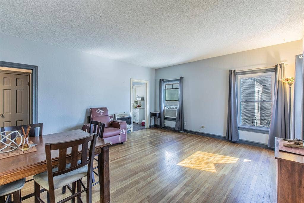 2603 Pine Avenue, Waco, TX 76708 Dining area with wood finished floors, a textured ceiling, and plenty of natural light