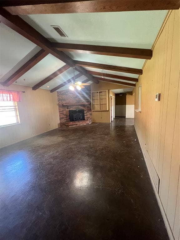 4038 State Highway 351, Abilene, TX 79601 Unfurnished living room with wooden walls, a fireplace, and ceiling fan