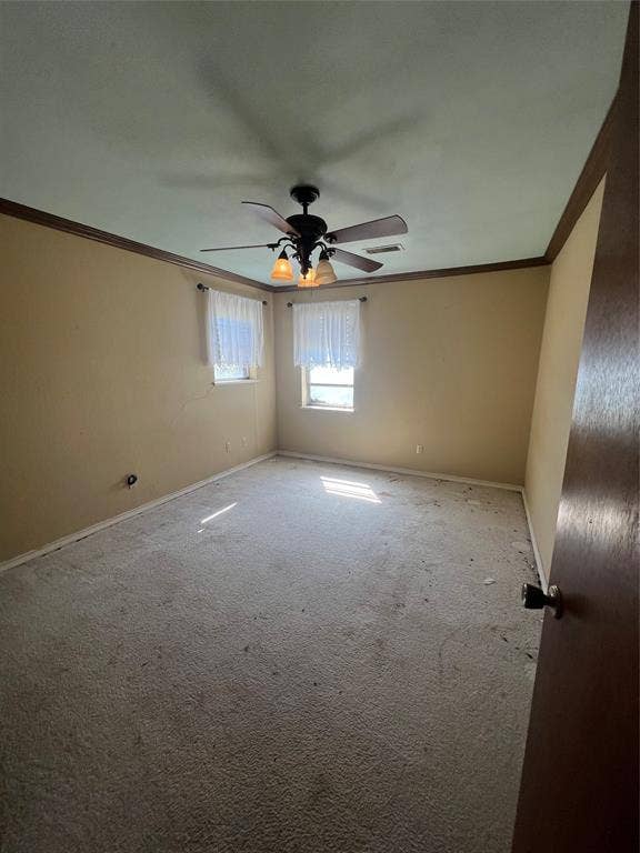 4038 State Highway 351, Abilene, TX 79601 Empty room featuring crown molding, carpet, and a ceiling fan
