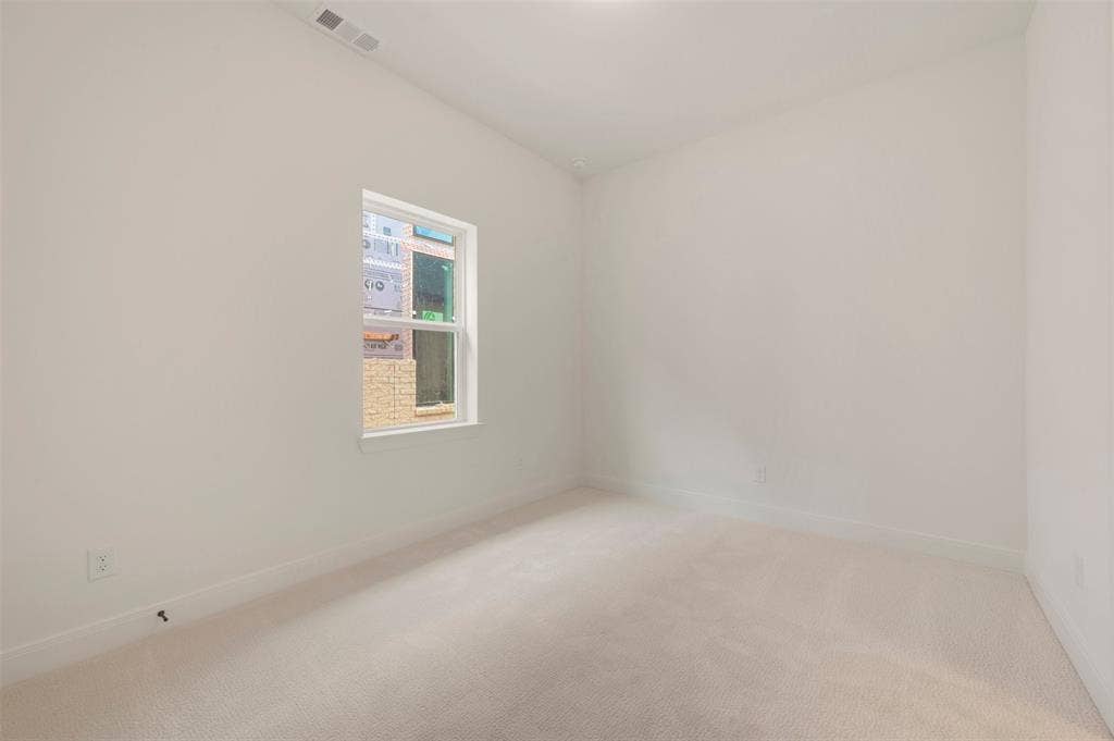 Neutral-toned carpeting and light-colored walls define this room