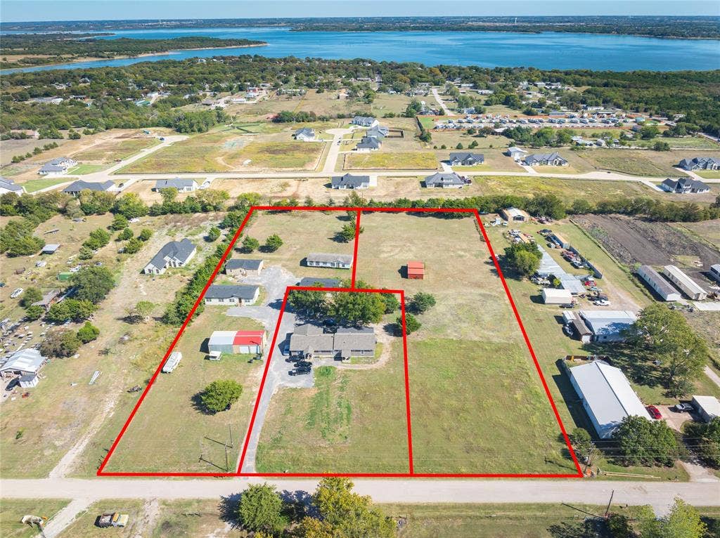 Aerial overview of property's location with a large body of water and property parcel outlined