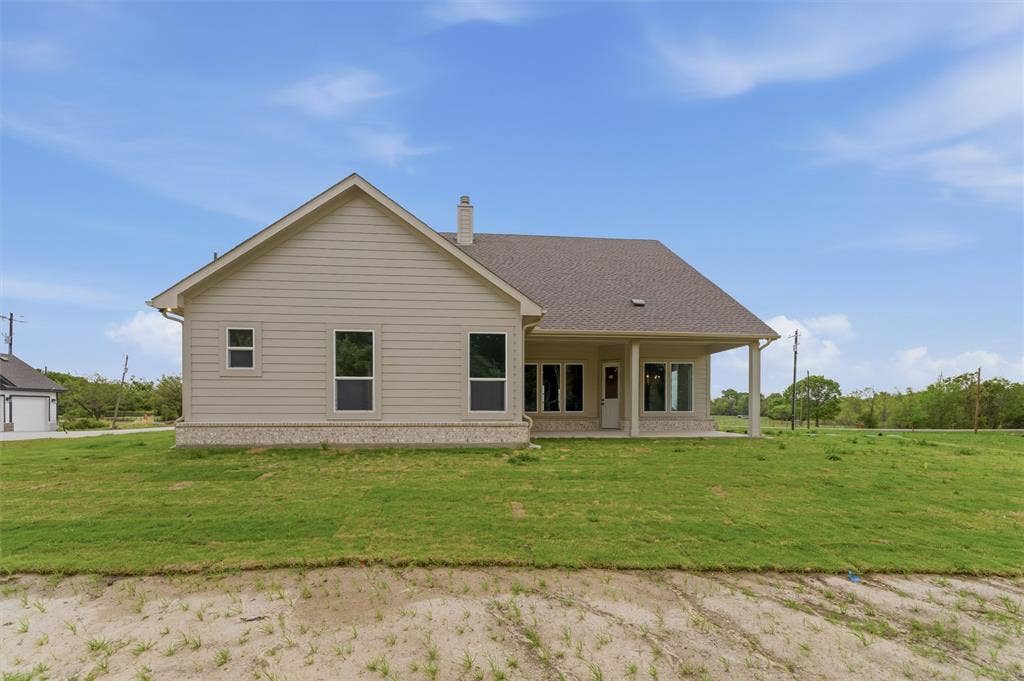 9007 County Road 623, Blue Ridge, TX 75424 Back of property featuring a yard, a patio area, a chimney, and roof with shingles