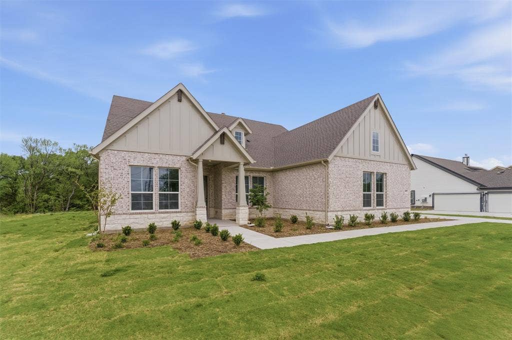 9007 County Road 623, Blue Ridge, TX 75424 View of front of property featuring board and batten siding, brick siding, a front yard, and roof with shingles