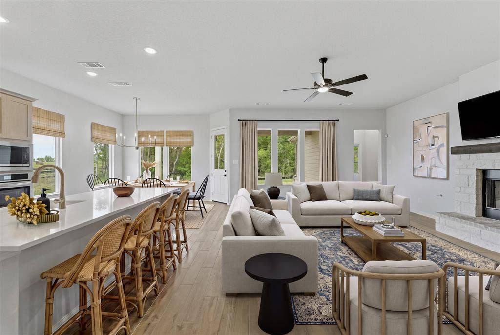 9007 County Road 623, Blue Ridge, TX 75424 Open-concept living area with wood-finish flooring, a white brick fireplace, and recessed lighting